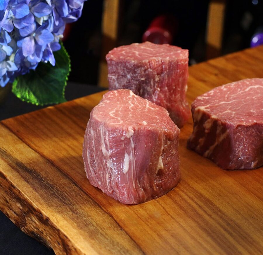 Filet mignon medallions on a wood board