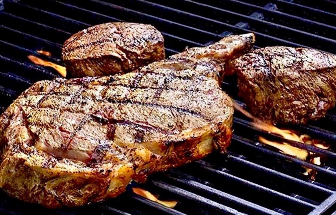 Prime ribeye steaks searing on the grill at Lee's Meat Market